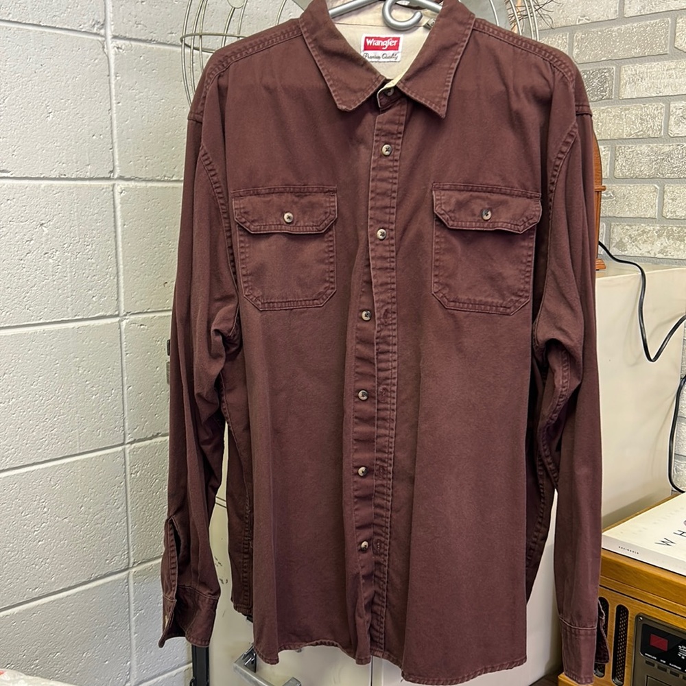 Men’s Wrangler button up shirt. One flaw noted in sleeve shown in picture.